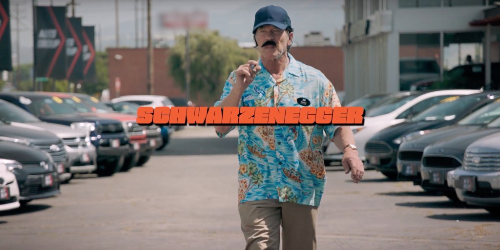 Watch a disguised Arnold Schwarzenegger try to sell gas cars to