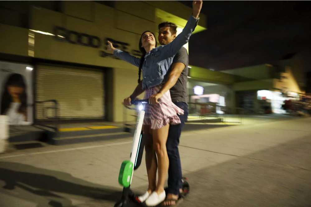 Tandem riding Lime scooter