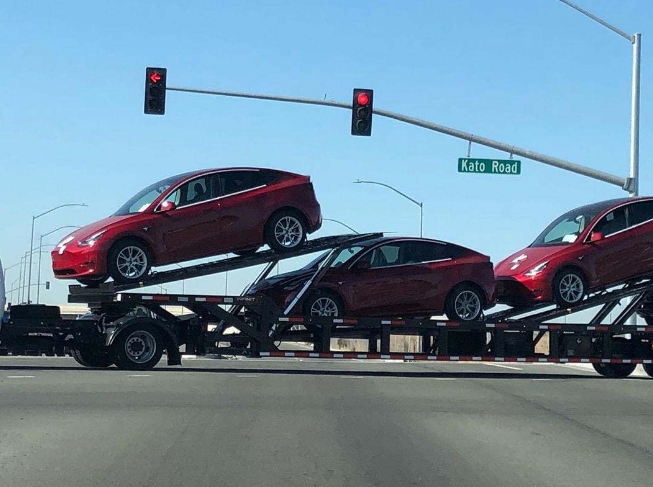 Tesla Model Y vehicles with new wheels spotted on carrier near factory