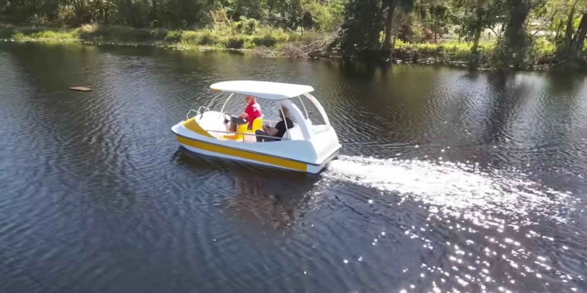 Mini speed boat cruising the pond 