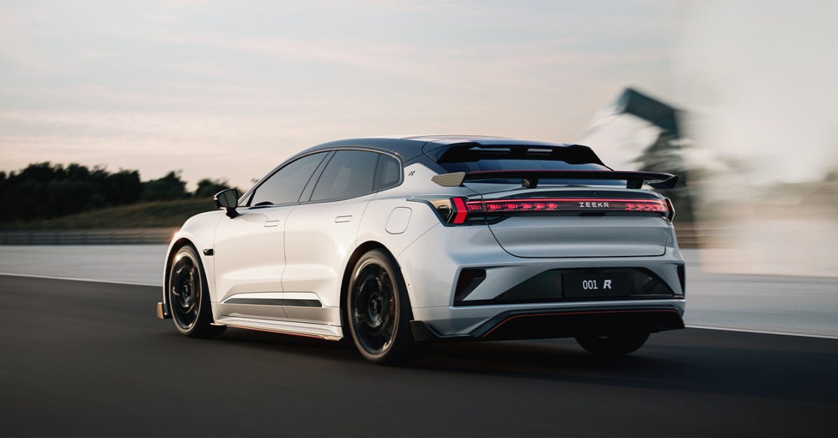 The sleek Zeekr 001 performance liftback finished in dark paint on a modern showroom floor.