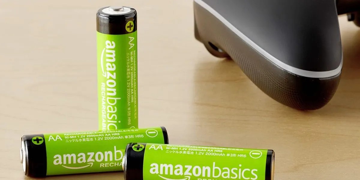 Amazon 2,000mAh rechargeable AA batteries on table next to gaming controller with post for Aventon Level.2 Step-Through Commuter e-bike