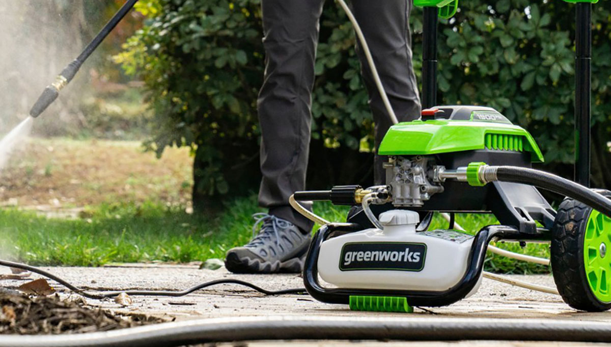 Greenworks 1900 PSI electric pressure washer being used on dirty driveway, within post for Gozl Zero Yeti power stations
