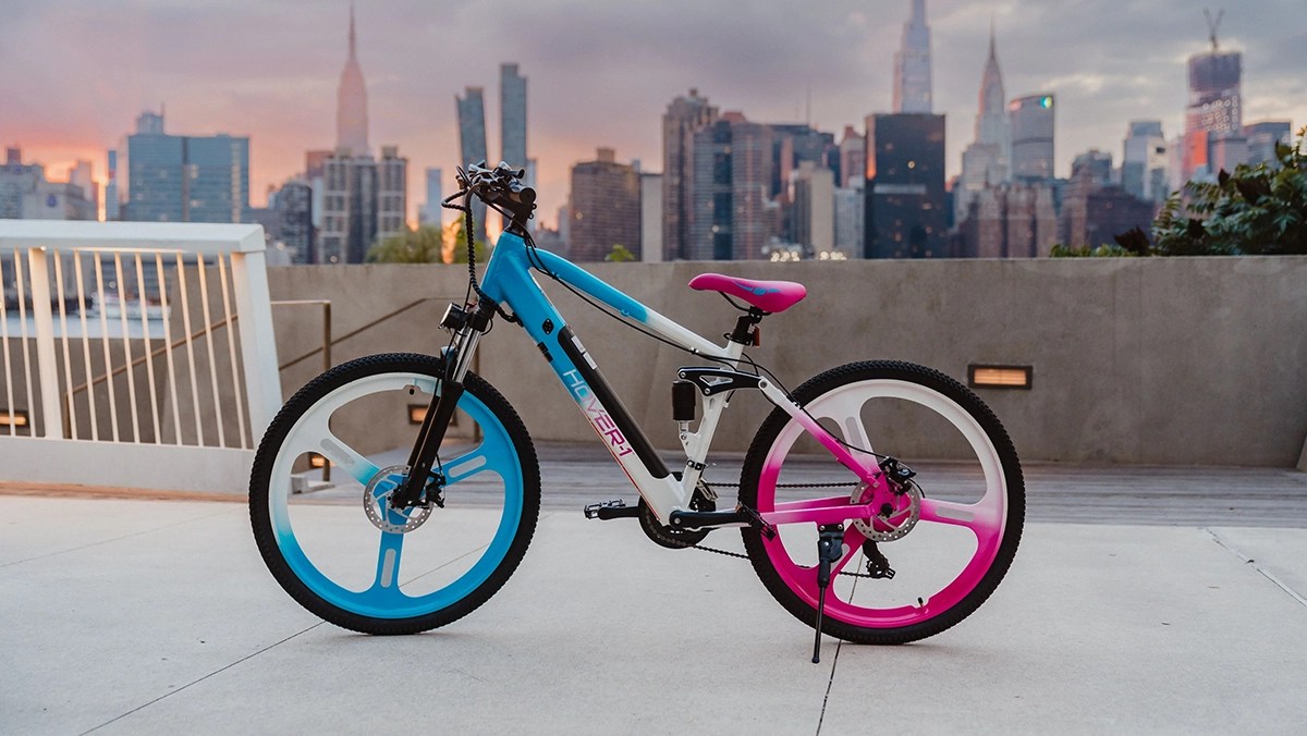 Hover-1 multi-color Instinct Electric Bike parked with kickstand with NYC skyline in background within post for Jackery Explorer 1000 v2 Portable Power Station