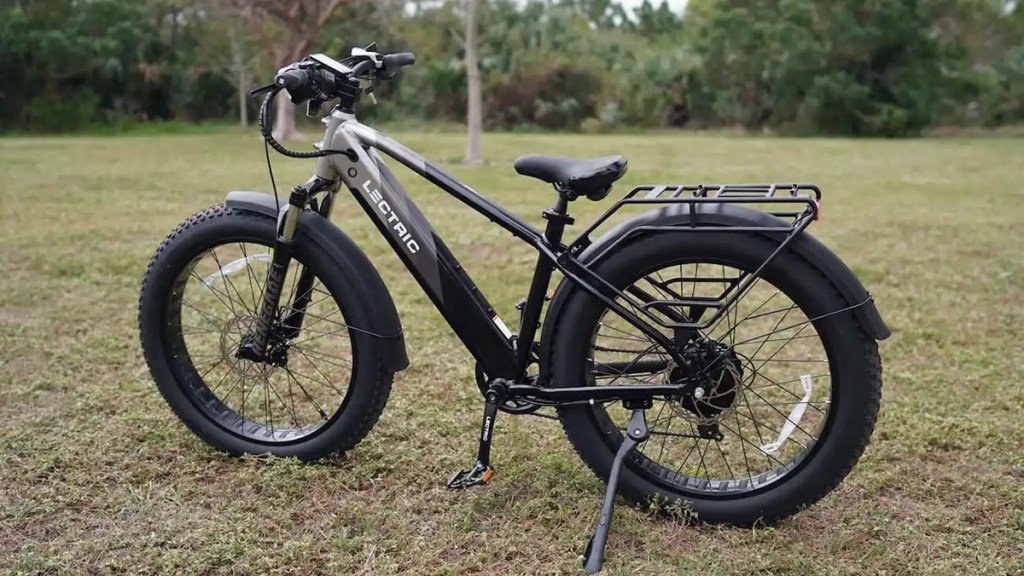 Lectric XPeak Off-Road e-bike parked in grass clearing, within post for Goal Zero Yeti power stations