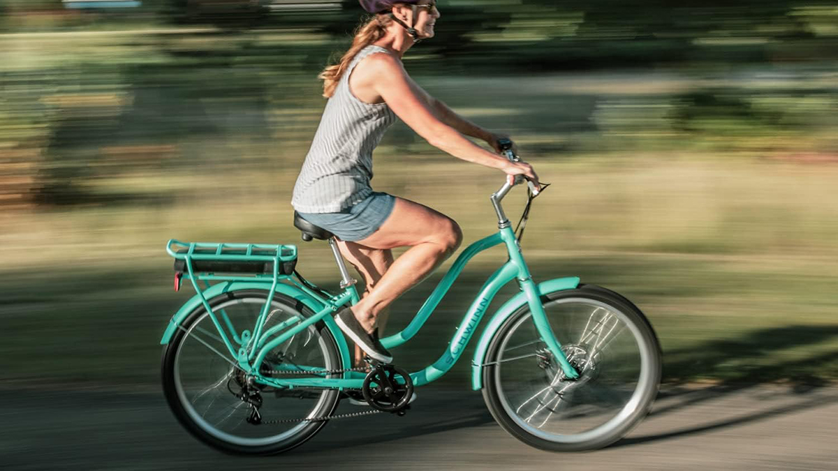 Schwinn Mendocino e-bike being ridden by smiling woman, within post for Juiced RipCurrent S e-bike