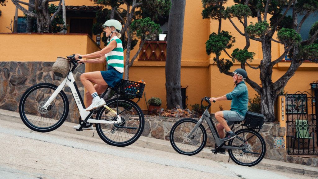 man and woman riding up hill on Aventon Pace 500.3 e-bikes
