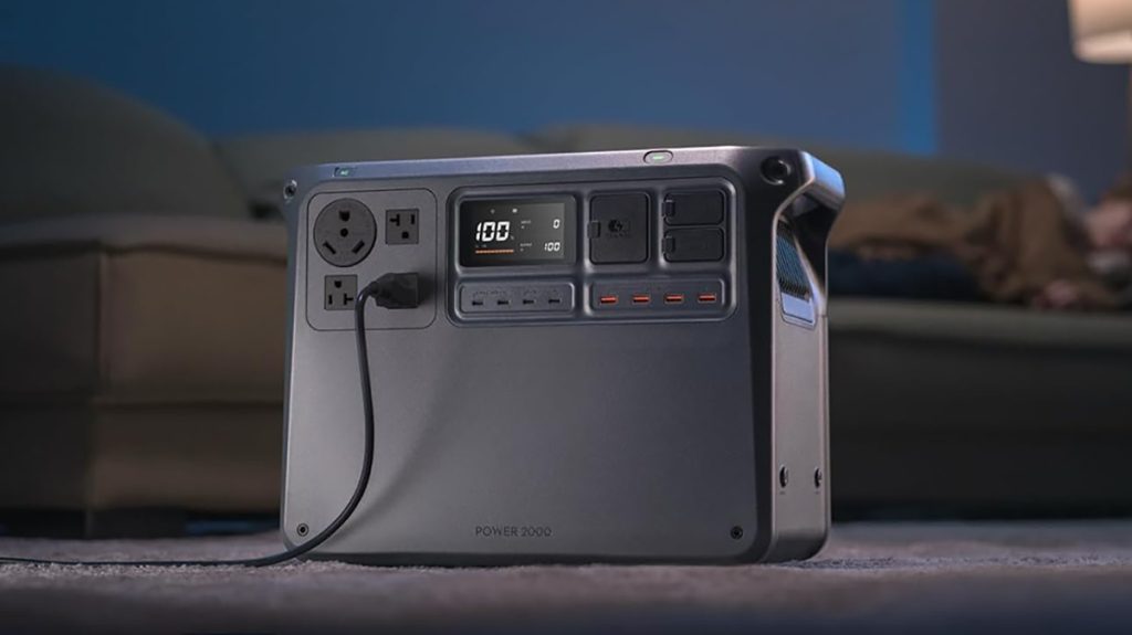 DJI Power 2000 power station in living room in front of couch with sleeping man