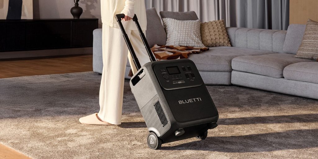 woman pulling Bluetti power station in home