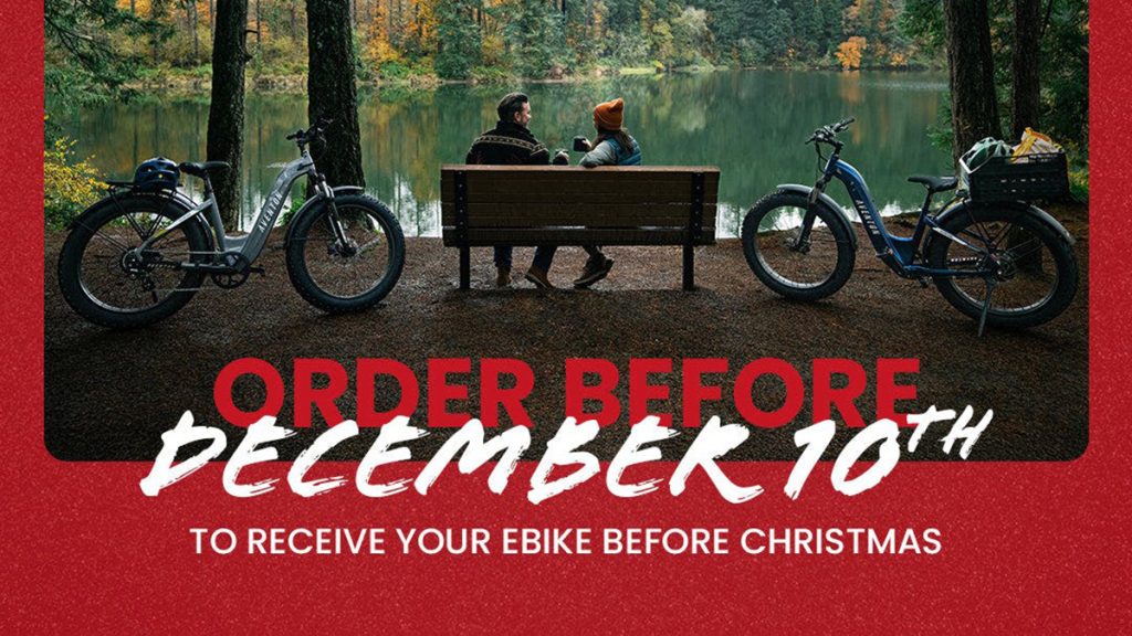 man and woman sitting on bench next to lake with Aventon e-bikes