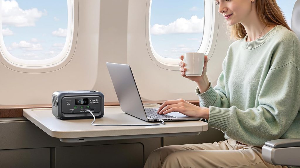 woman using Bluetti Elite 10 mini power station to charge laptop on plane