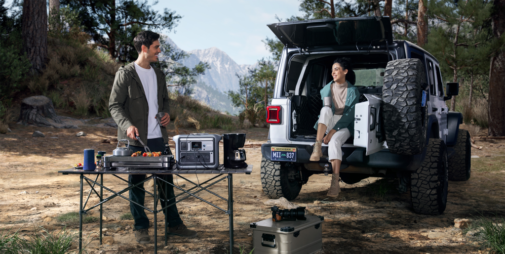 man and woman camping with Anker SOLIX power station