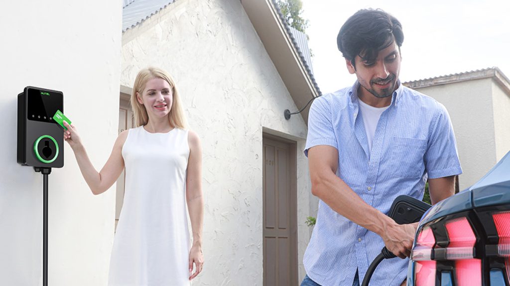man and woman using Autel EV charger to power vehicle