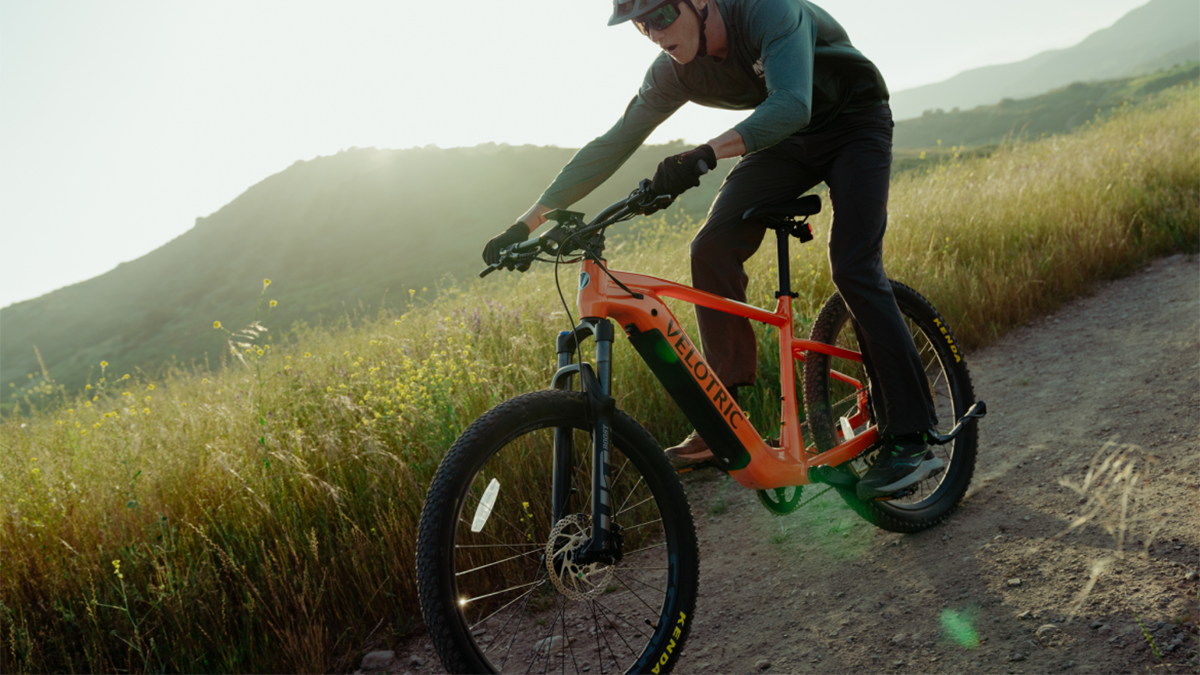 Man riding Velotric Summit 1 e-bike down off-road hill