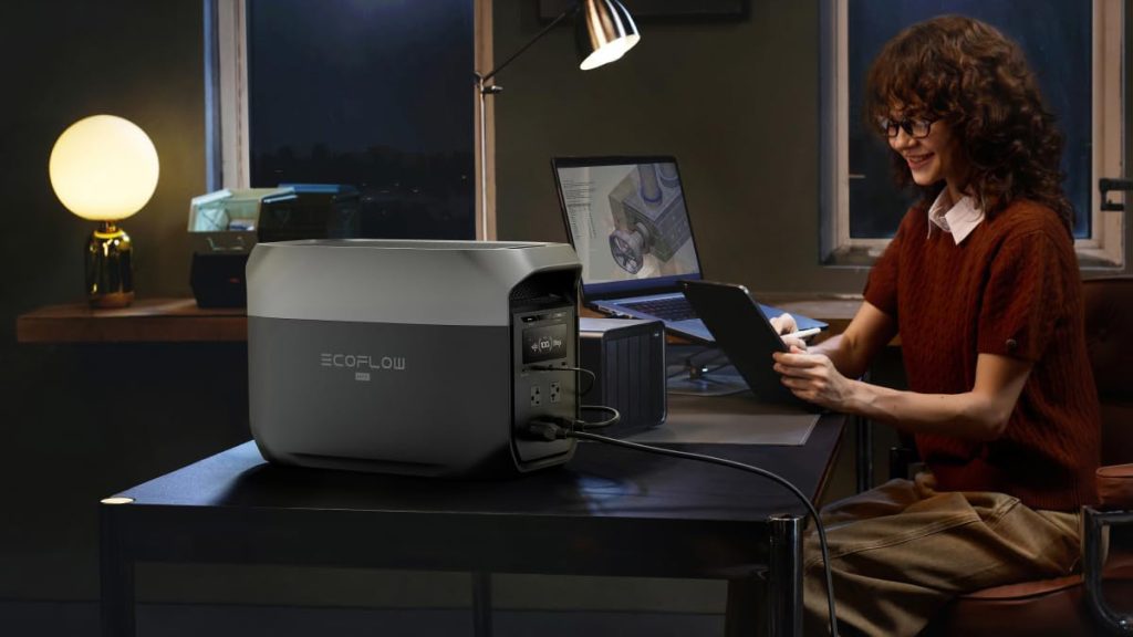 woman sitting at desk with ecoflow portable power station