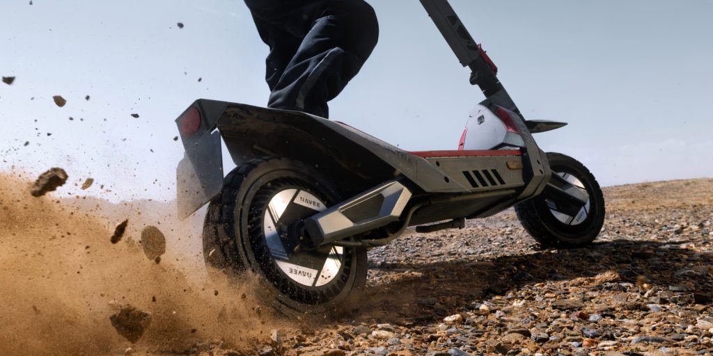 electric scooter kicking up rocks and dirt