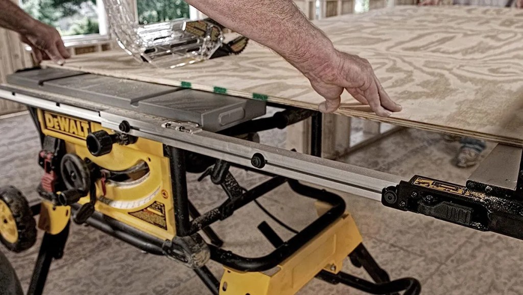 man using DEWALT 10-inch table saw at jobsite