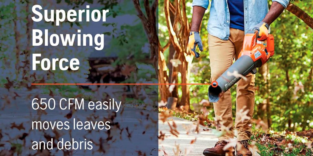 man using husqvarna electric leaf blower to clear sidewalk