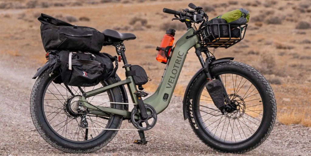 velotric e-bike carrying bags in desert