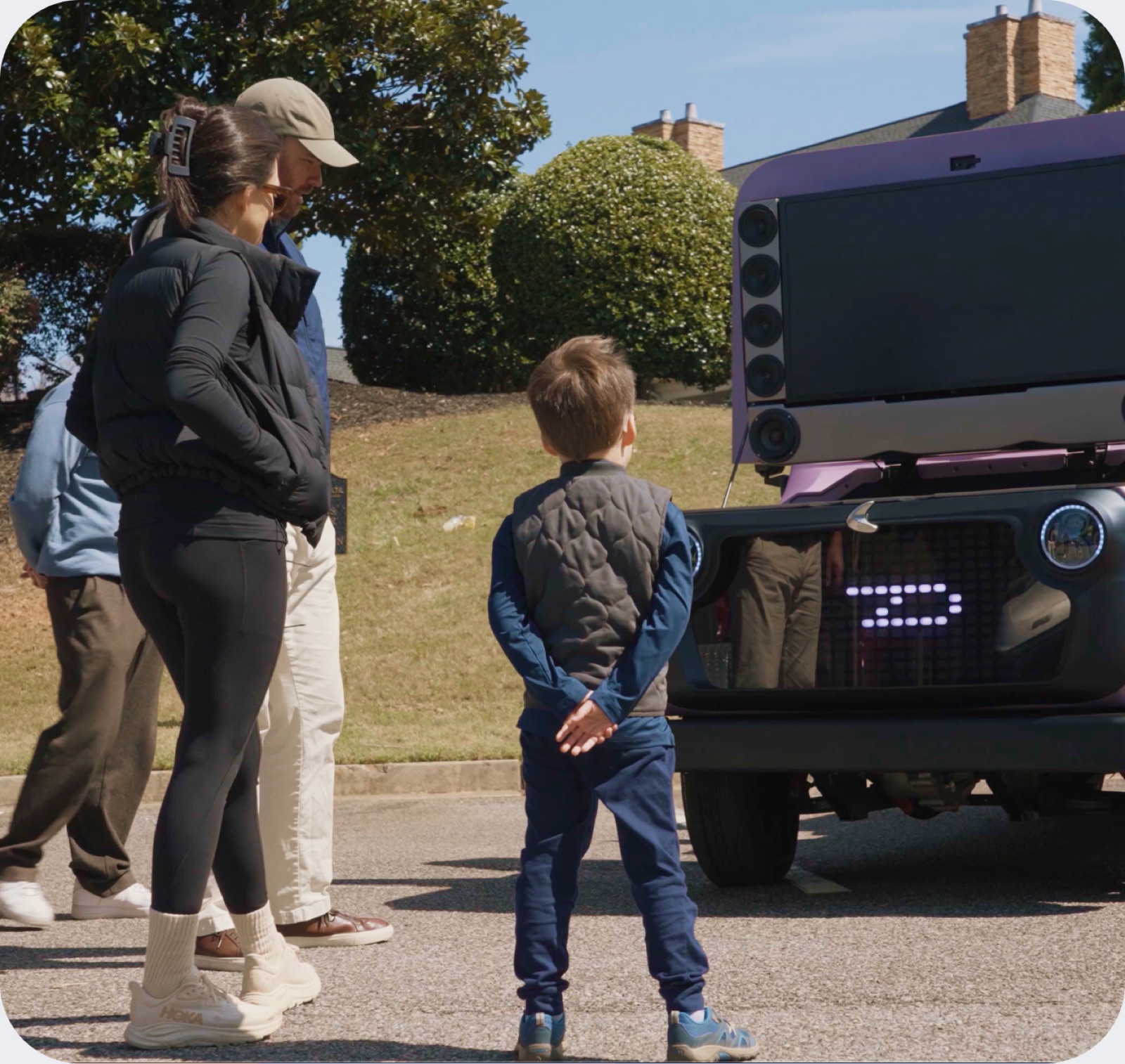 A parent and child looking at the Chip LUV rear display