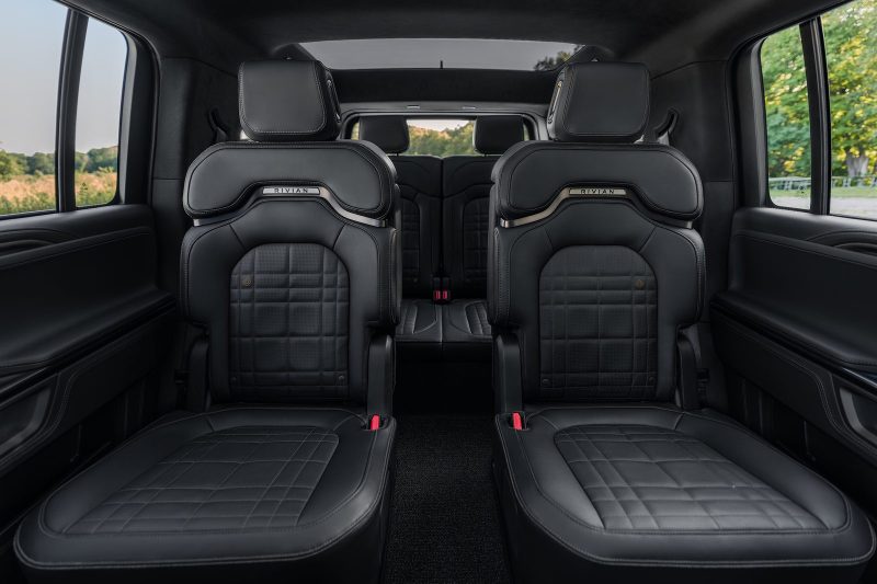 2027 Rivian R1S captain's chairs in the dark Black Mountain interior
