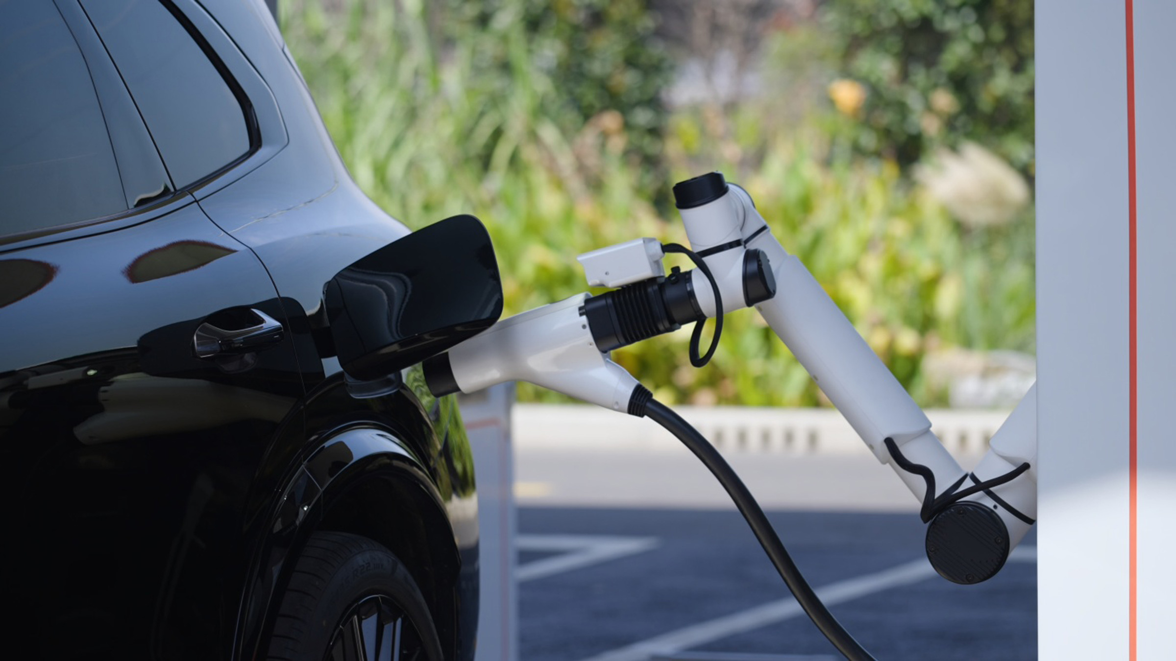 Geely Smart Charging robotic arm plugging into an EV