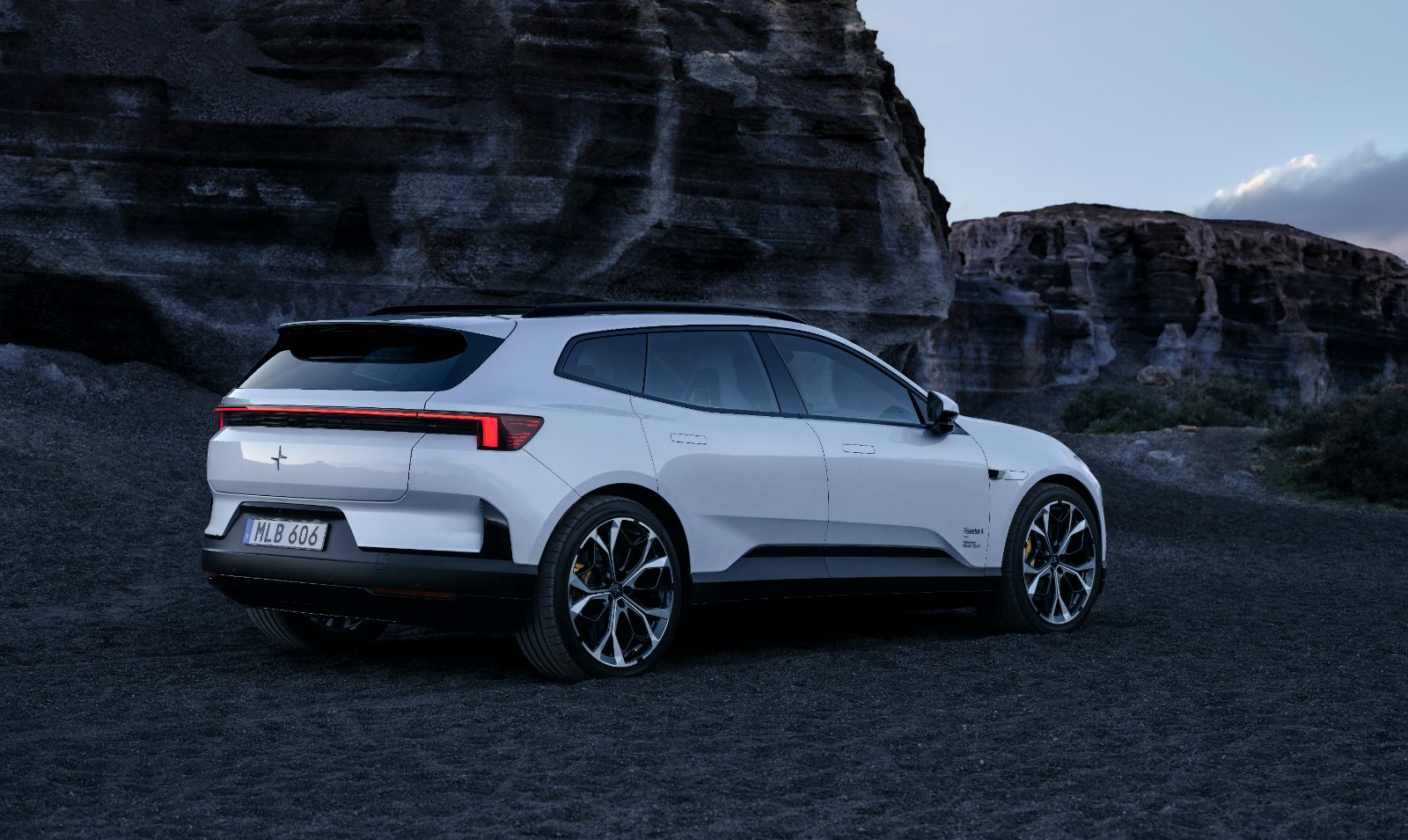 Polestar 4 SUV rear three-quarter view in a rocky landscape, showing its rear window