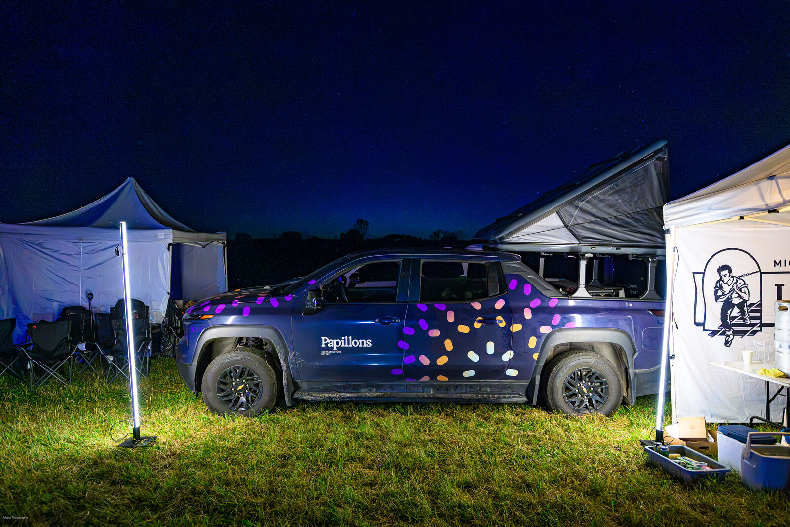 Papillons-branded Chevy Silverado EV at night during the Le gout du paysage tour