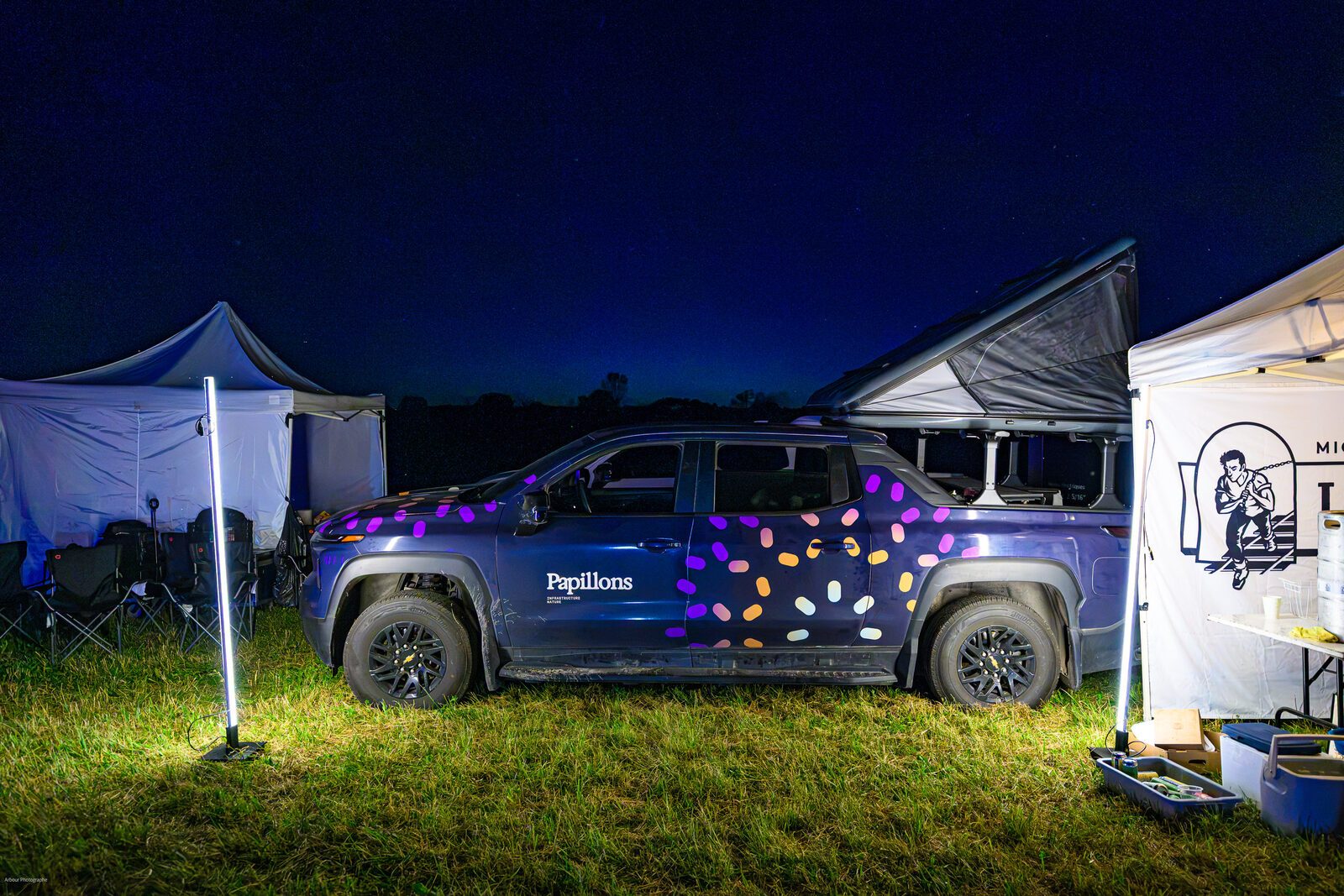 Papillons-branded Chevy Silverado EV at night during the Le gout du paysage tour