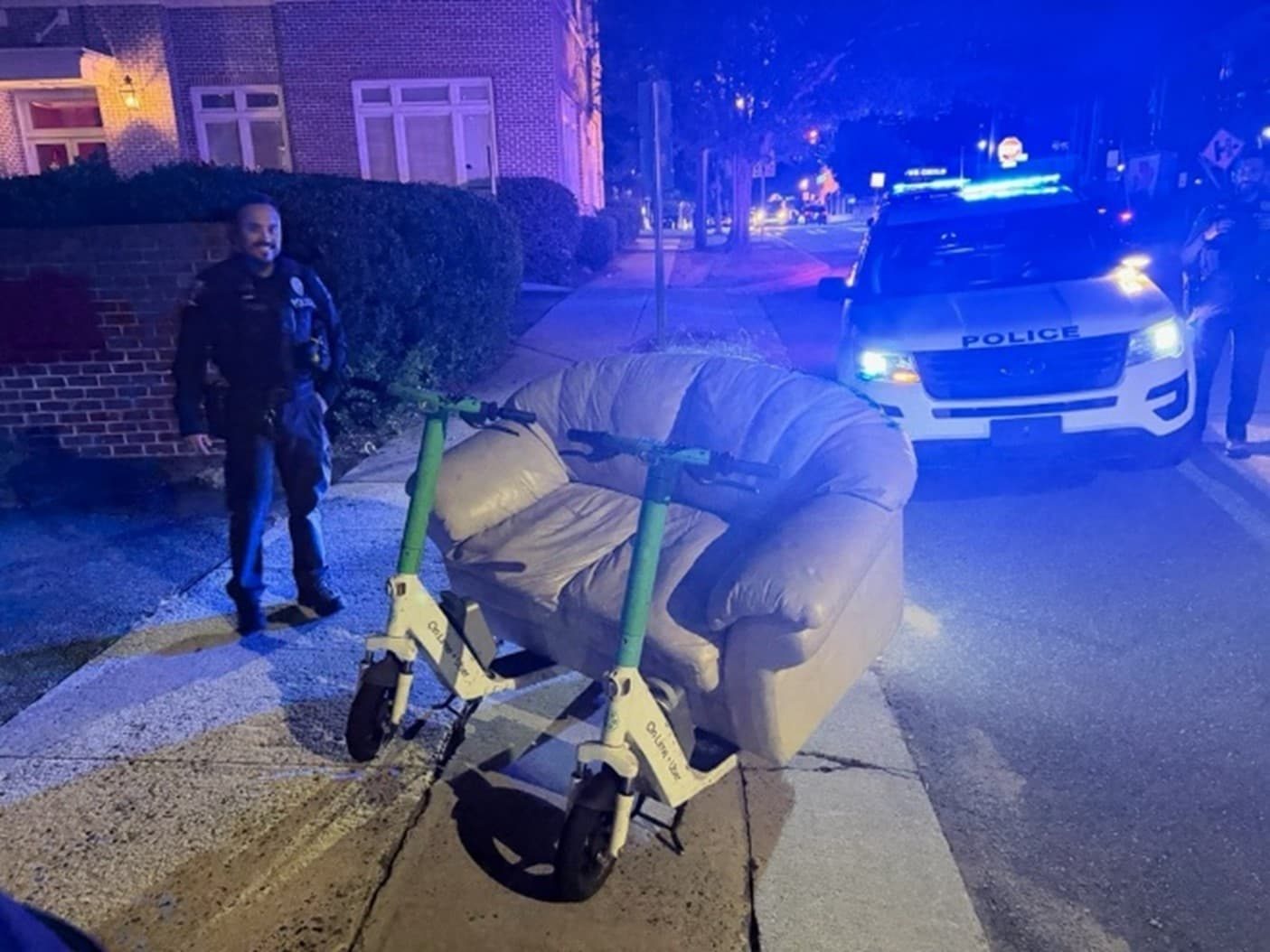 Charlotte Police Stop Two Men Riding a Couch Powered by Lime Electric Scooters