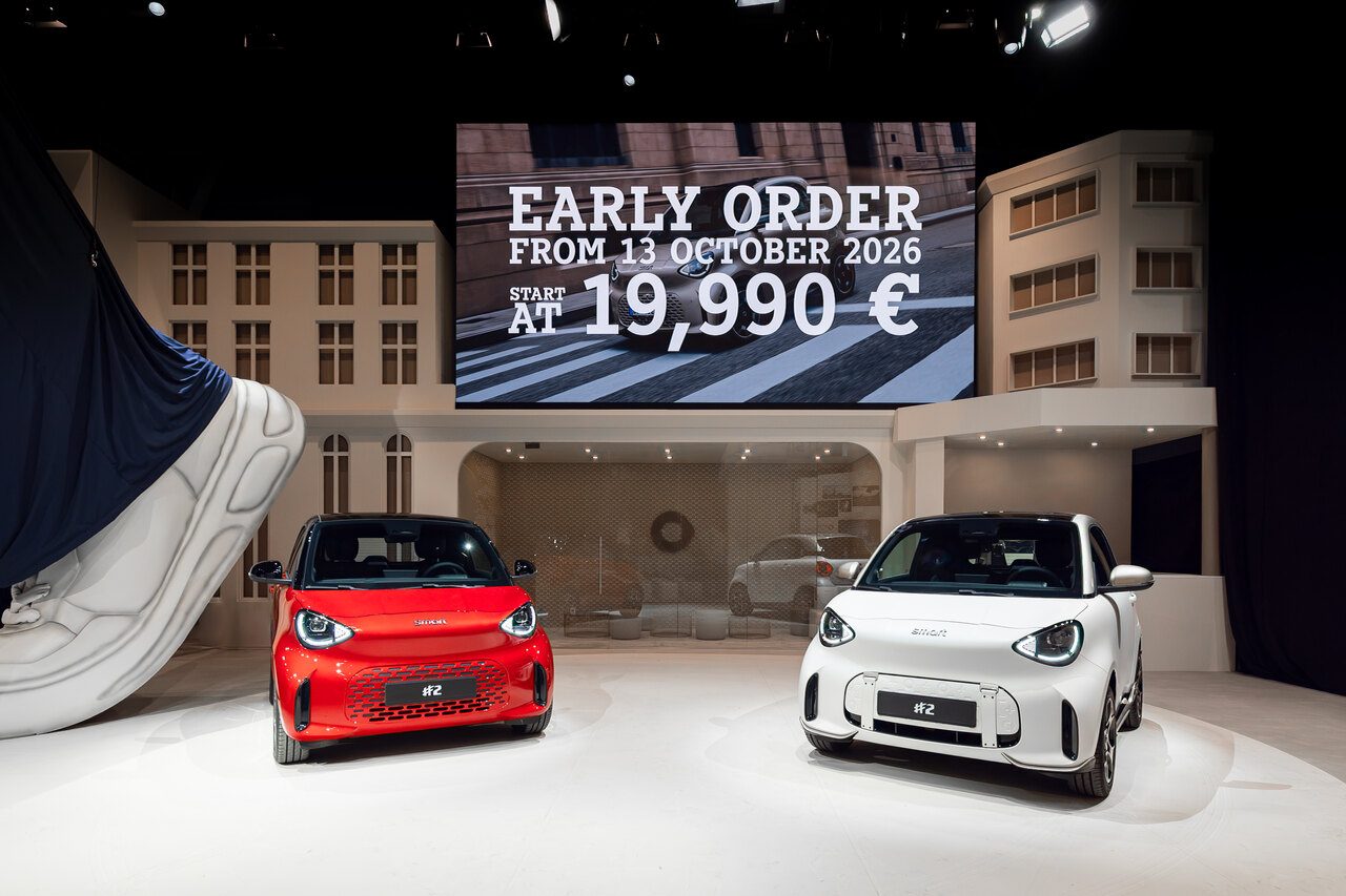 Two Smart #2 cars on the smart stand at the Paris Motor Show under an early order sign showing 19,990 euros